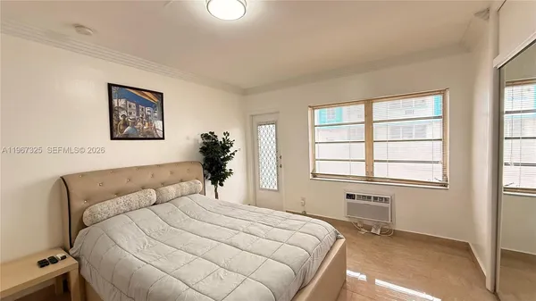 a bedroom with a large bed and a flat screen tv