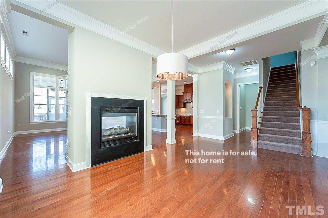 1225 Chapanoke Road Raleigh, NC 27603 - Photo 13 of 27 a view of a hallway with wooden floor and a living room