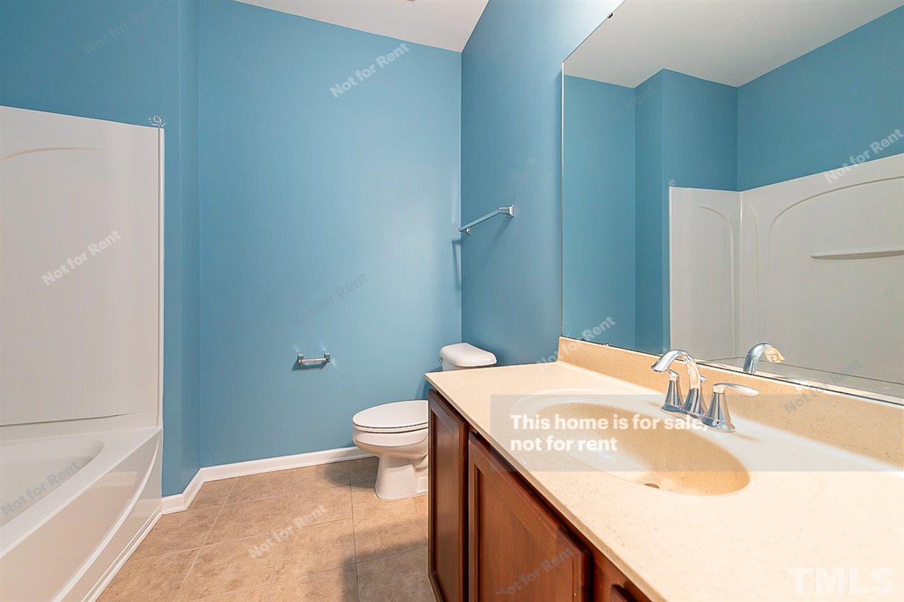1225 Chapanoke Road Raleigh, NC 27603 - Photo 22 of 27 a bathroom with a sink toilet and vanity