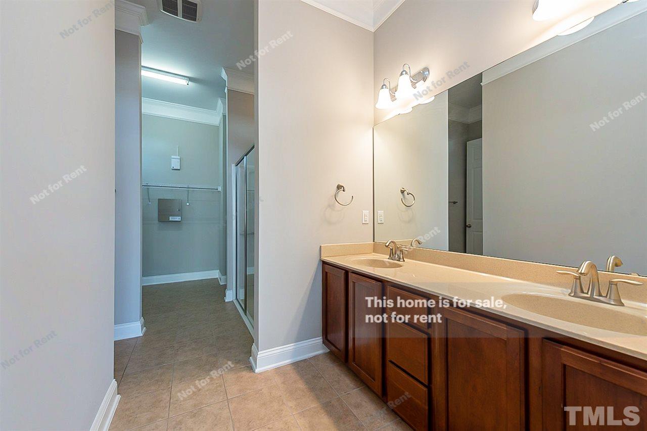 1225 Chapanoke Road Raleigh, NC 27603 - Photo 4 of 27 a bathroom with a double vanity sink and a mirror
