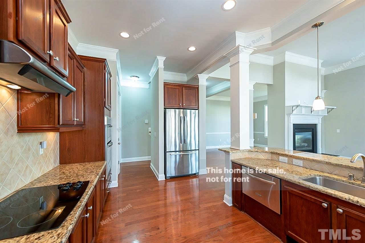 1225 Chapanoke Road Raleigh, NC 27603 - Photo 7 of 27 a kitchen with stainless steel appliances granite countertop a stove and a refrigerator