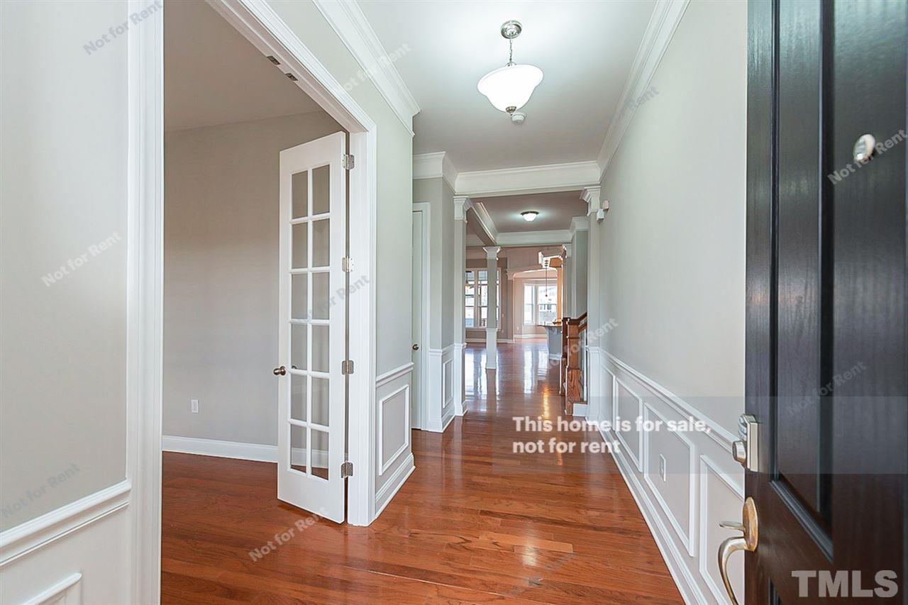 1225 Chapanoke Road Raleigh, NC 27603 - Photo 9 of 27 a view of a hallway with wooden floor and staircase