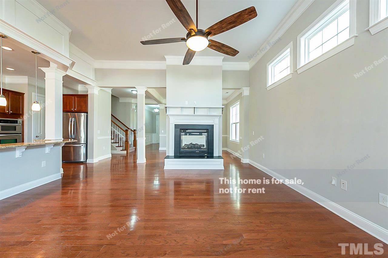 1225 Chapanoke Road Raleigh, NC 27603 - Photo 10 of 27 a view of an empty room with wooden floor fireplace and a window