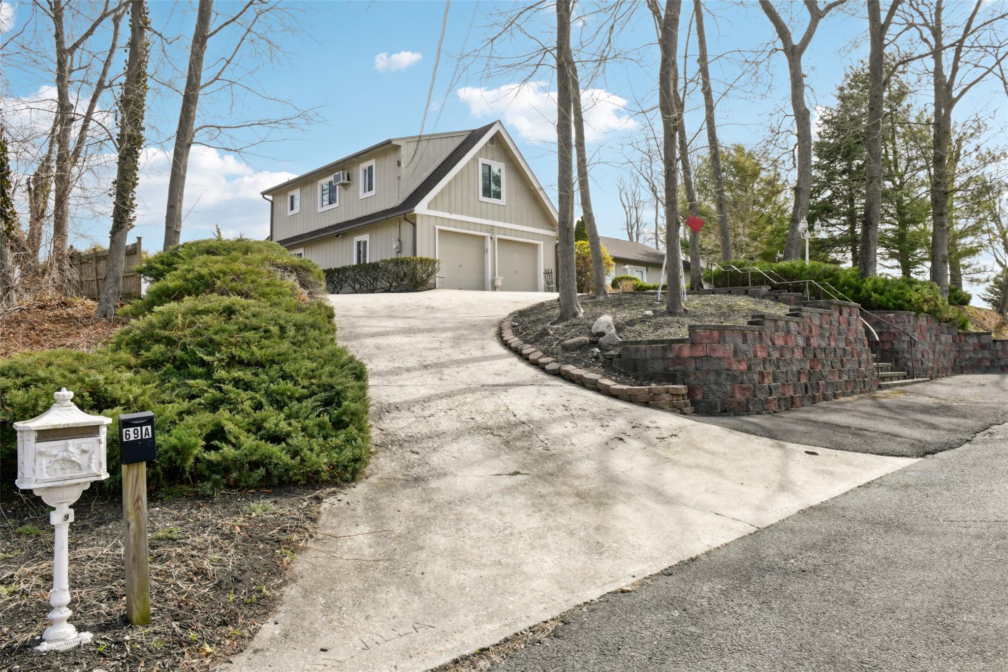 View of property exterior featuring driveway and a garage