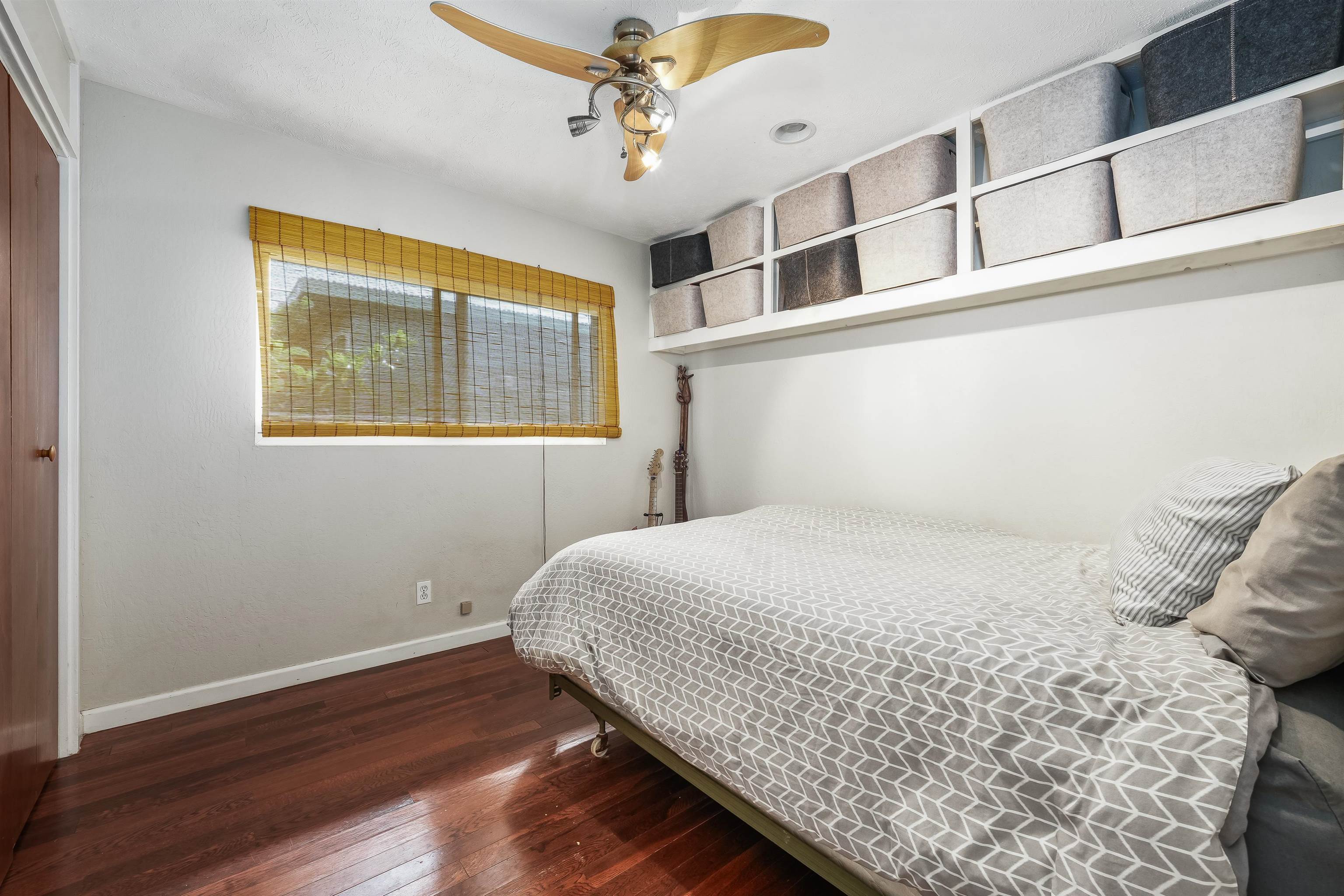 2889 West Lelehuna Place Haiku, HI 96708 - Photo 13 of 32 a bedroom with a bed and wooden floor