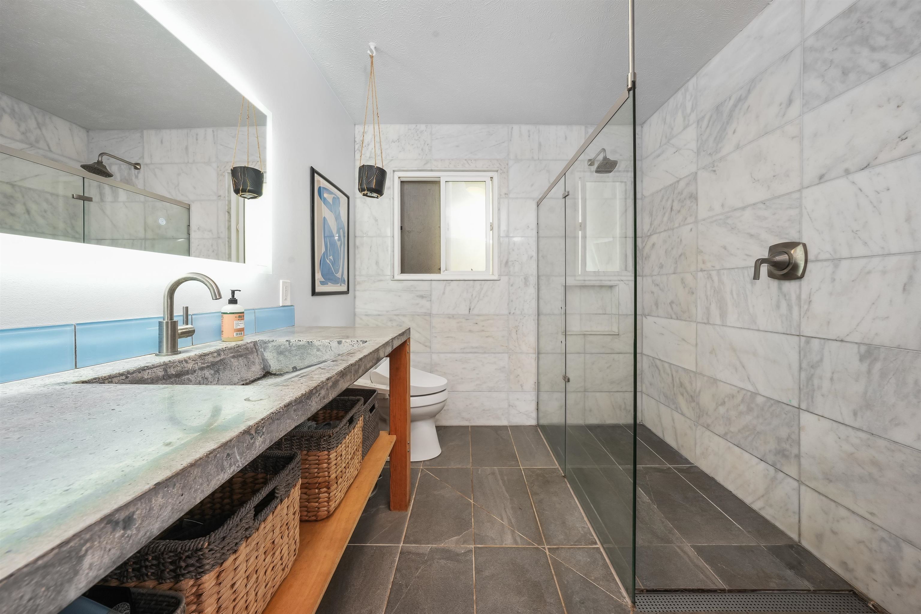 2889 West Lelehuna Place Haiku, HI 96708 - Photo 15 of 32 a spacious bathroom with a granite countertop sink a toilet a mirror and shower