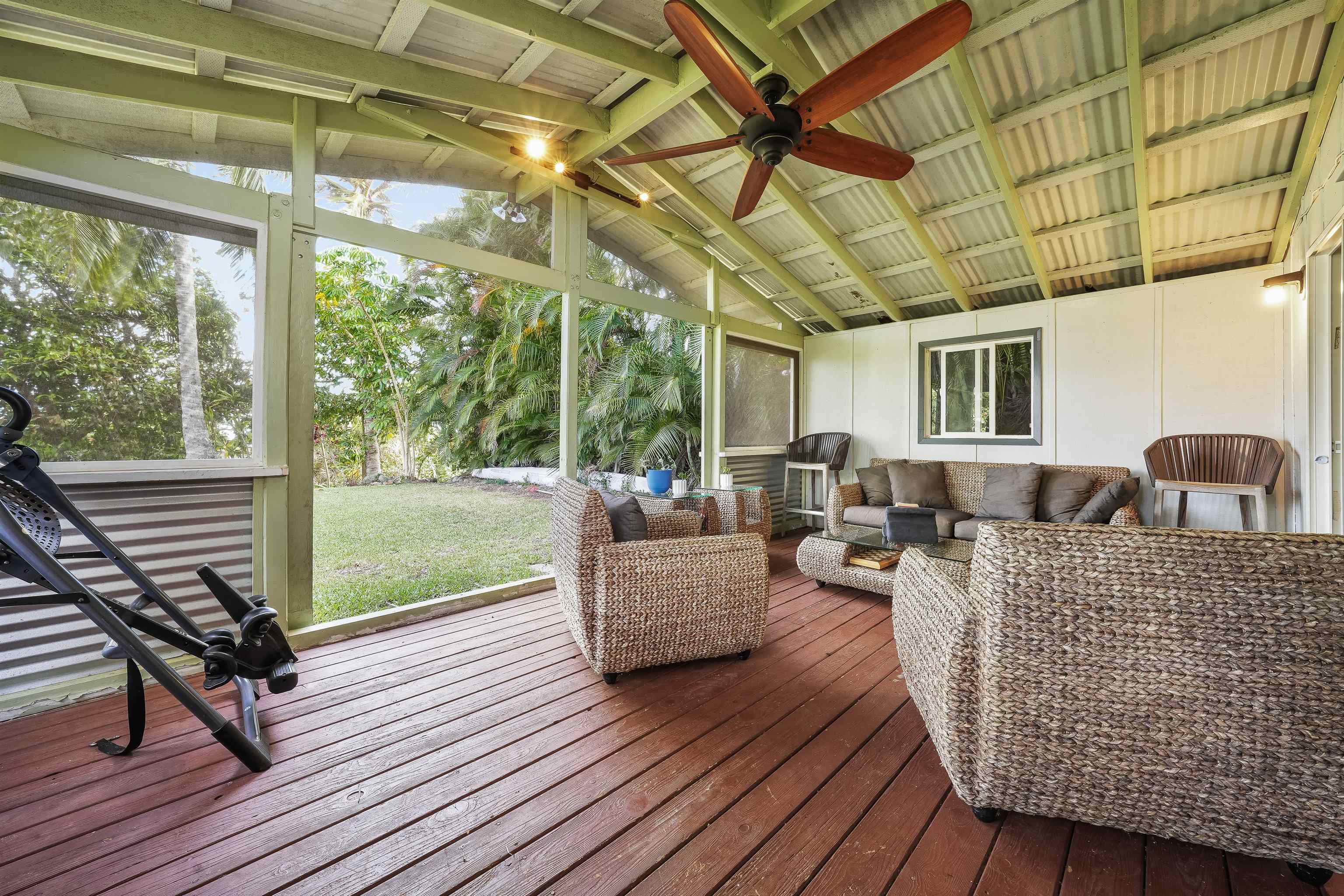 2889 West Lelehuna Place Haiku, HI 96708 - Photo 23 of 32 a living room with furniture a wooden floor and next to a window