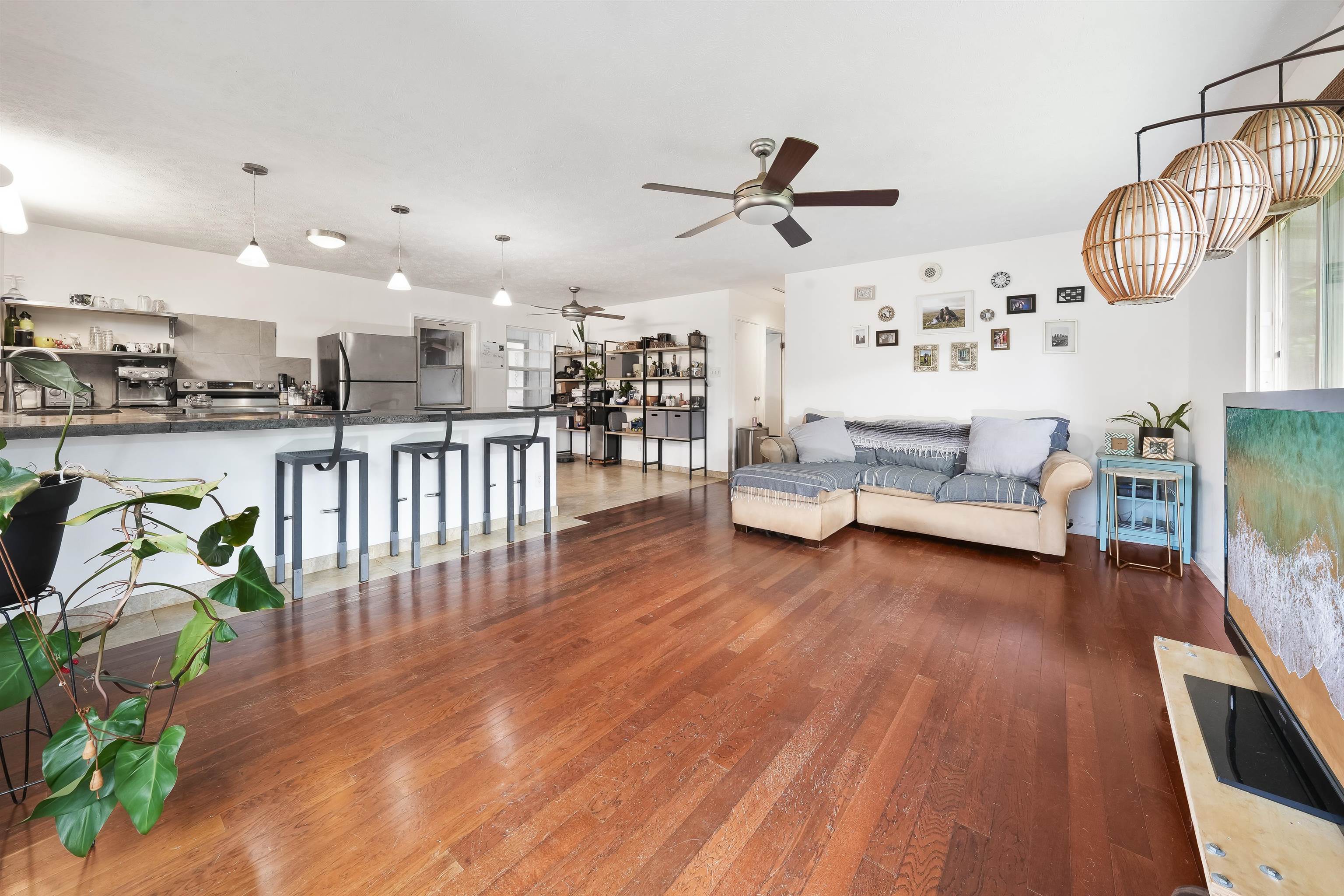 2889 West Lelehuna Place Haiku, HI 96708 - Photo 6 of 32 a view of a living room and kitchen with furniture wooden floor and windows