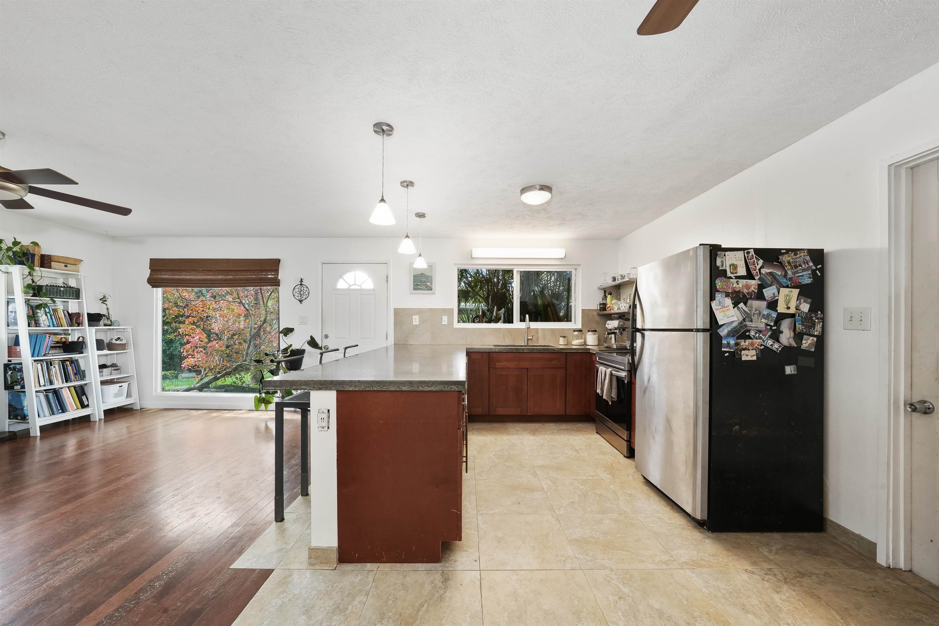 2889 West Lelehuna Place Haiku, HI 96708 - Photo 10 of 32 a living room with furniture a refrigerator and wooden floor