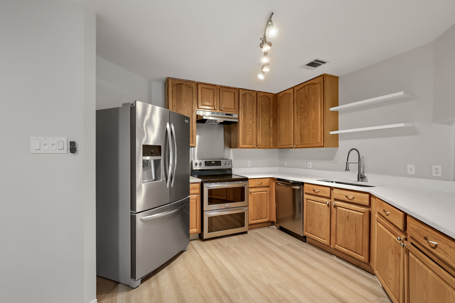 7411 Pusch Ridge Loop Austin, TX 78749 - Photo 11 of 29 a kitchen with stainless steel appliances a refrigerator sink and cabinets
