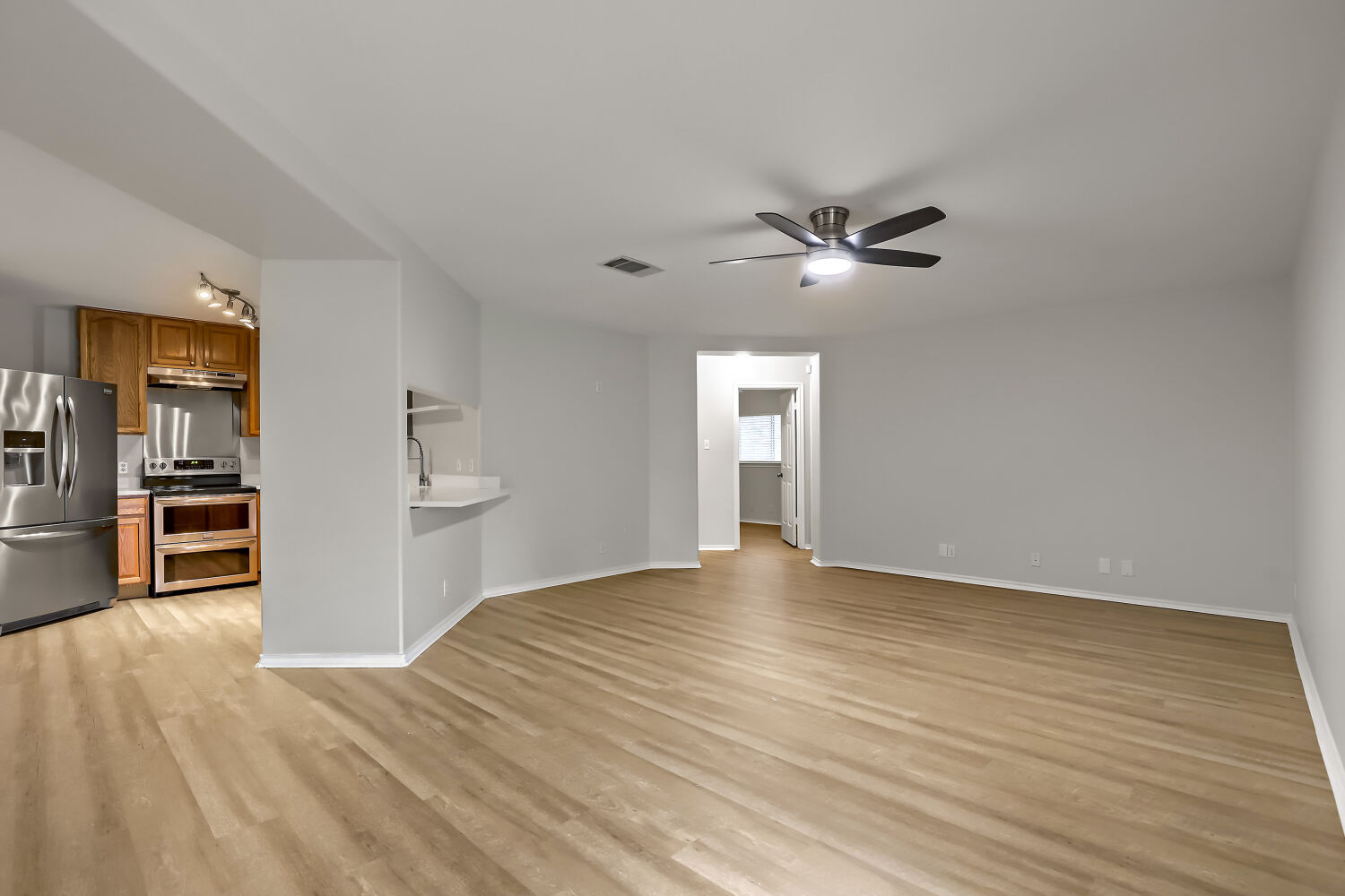 7411 Pusch Ridge Loop Austin, TX 78749 - Photo 13 of 29 a view of an empty room with a kitchen