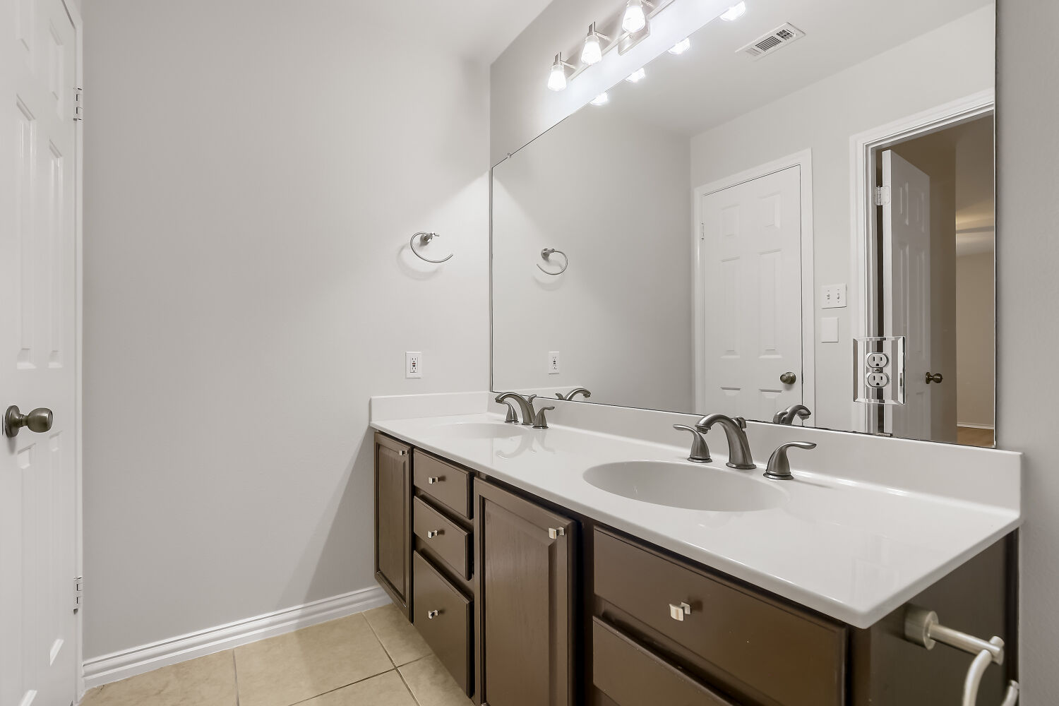 7411 Pusch Ridge Loop Austin, TX 78749 - Photo 19 of 29 a bathroom with a sink a light fixture and a mirror