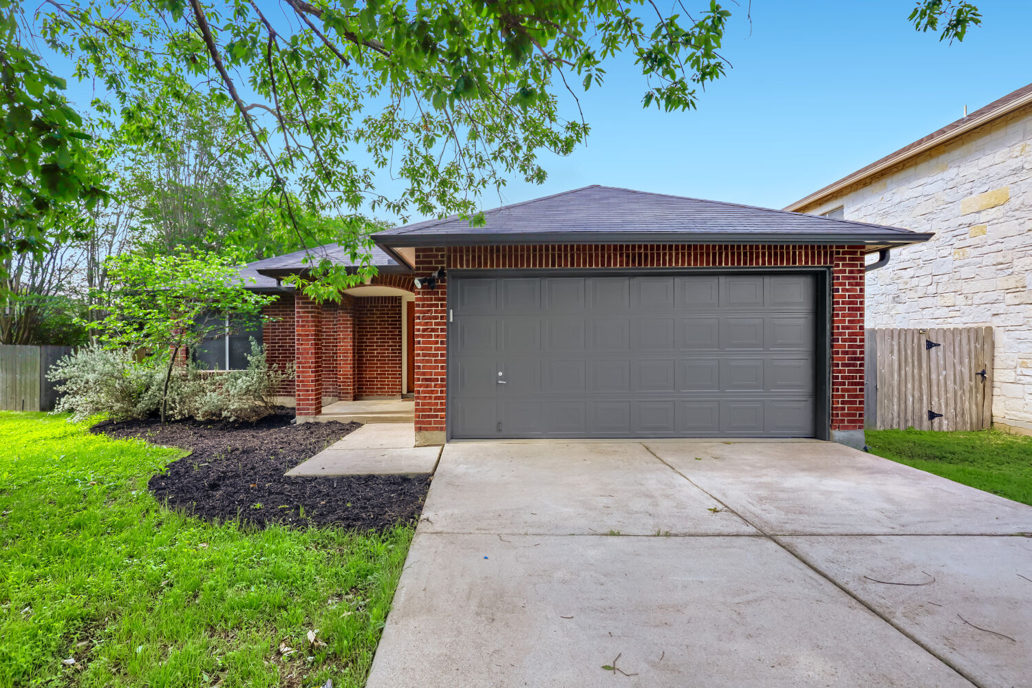 7411 Pusch Ridge Loop Austin, TX 78749 - Photo 2 of 29 a front view of a house with a yard and garage