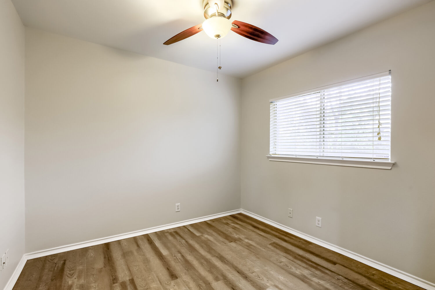 7411 Pusch Ridge Loop Austin, TX 78749 - Photo 21 of 29 a view of an empty room with wooden floor and a window