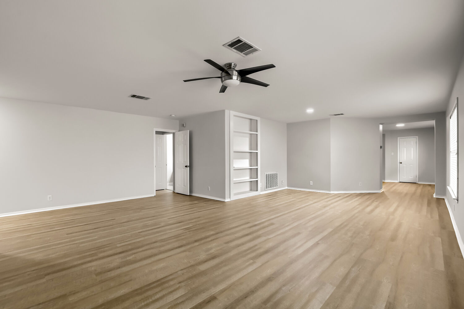 7411 Pusch Ridge Loop Austin, TX 78749 - Photo 3 of 29 a view of empty room with wooden floor and ceiling fan
