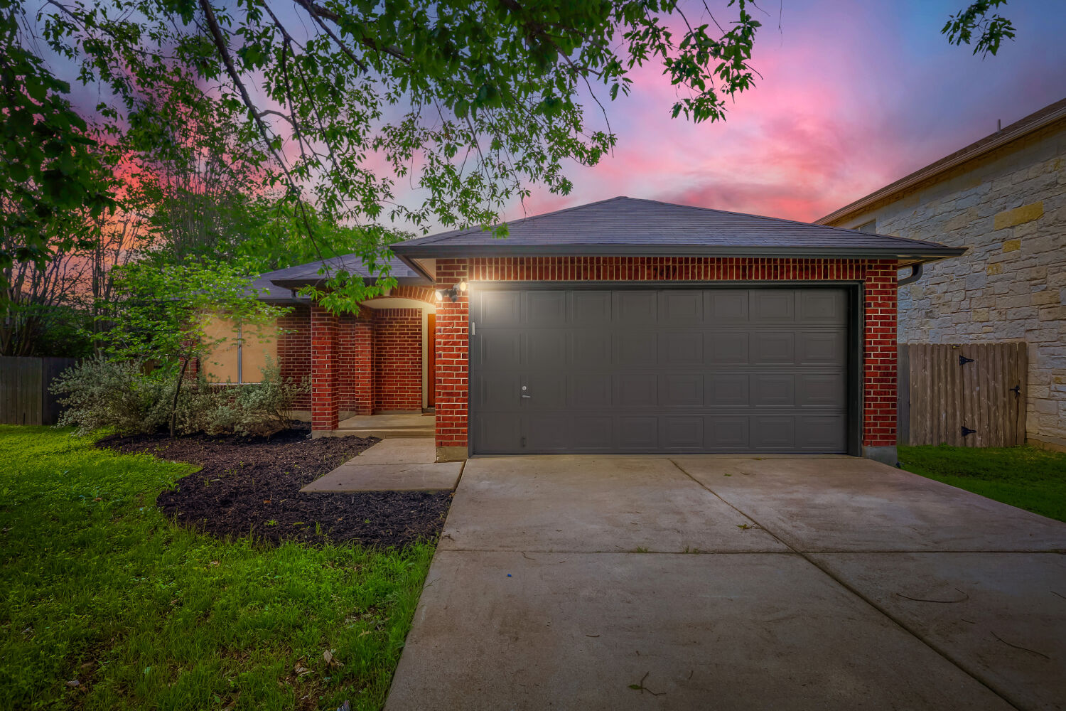 7411 Pusch Ridge Loop Austin, TX 78749 - Photo 5 of 29 a front view of a house with a yard and garage