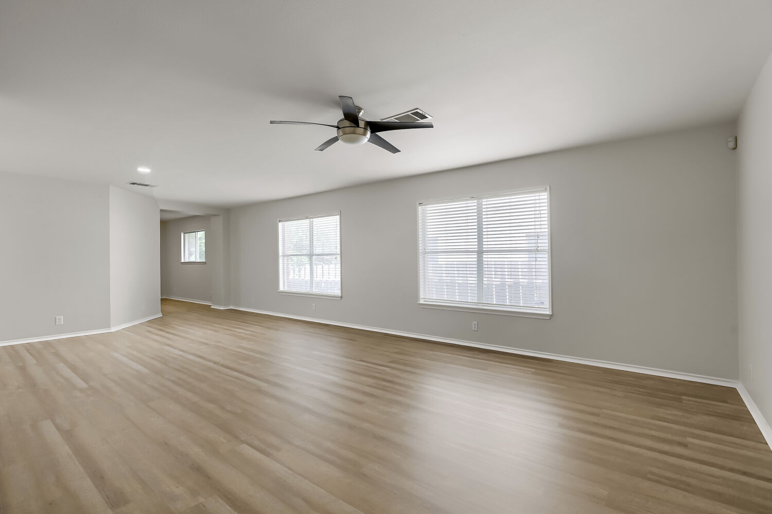 7411 Pusch Ridge Loop Austin, TX 78749 - Photo 7 of 29 a view of empty room with wooden floor and fan