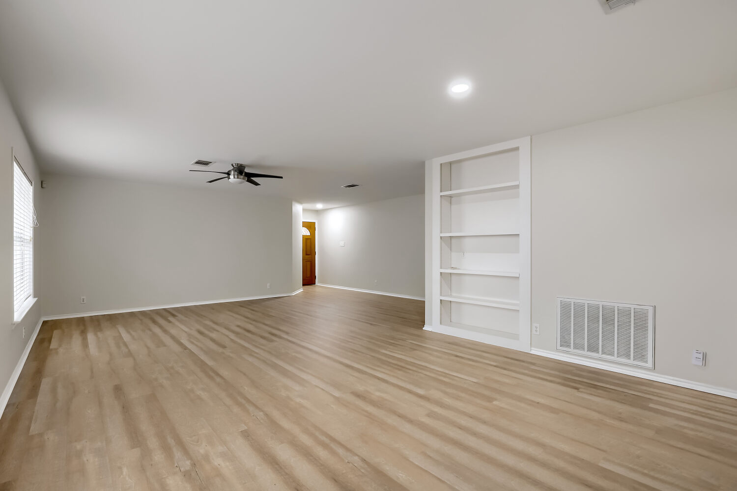 7411 Pusch Ridge Loop Austin, TX 78749 - Photo 8 of 29 a view of empty room with wooden floor and fan