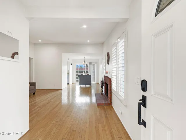 a view of a room with wooden floor and furniture