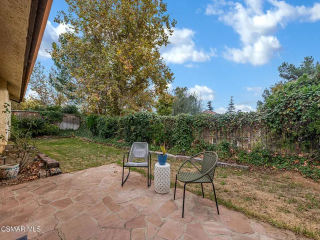 a view of a chairs and table in the garden