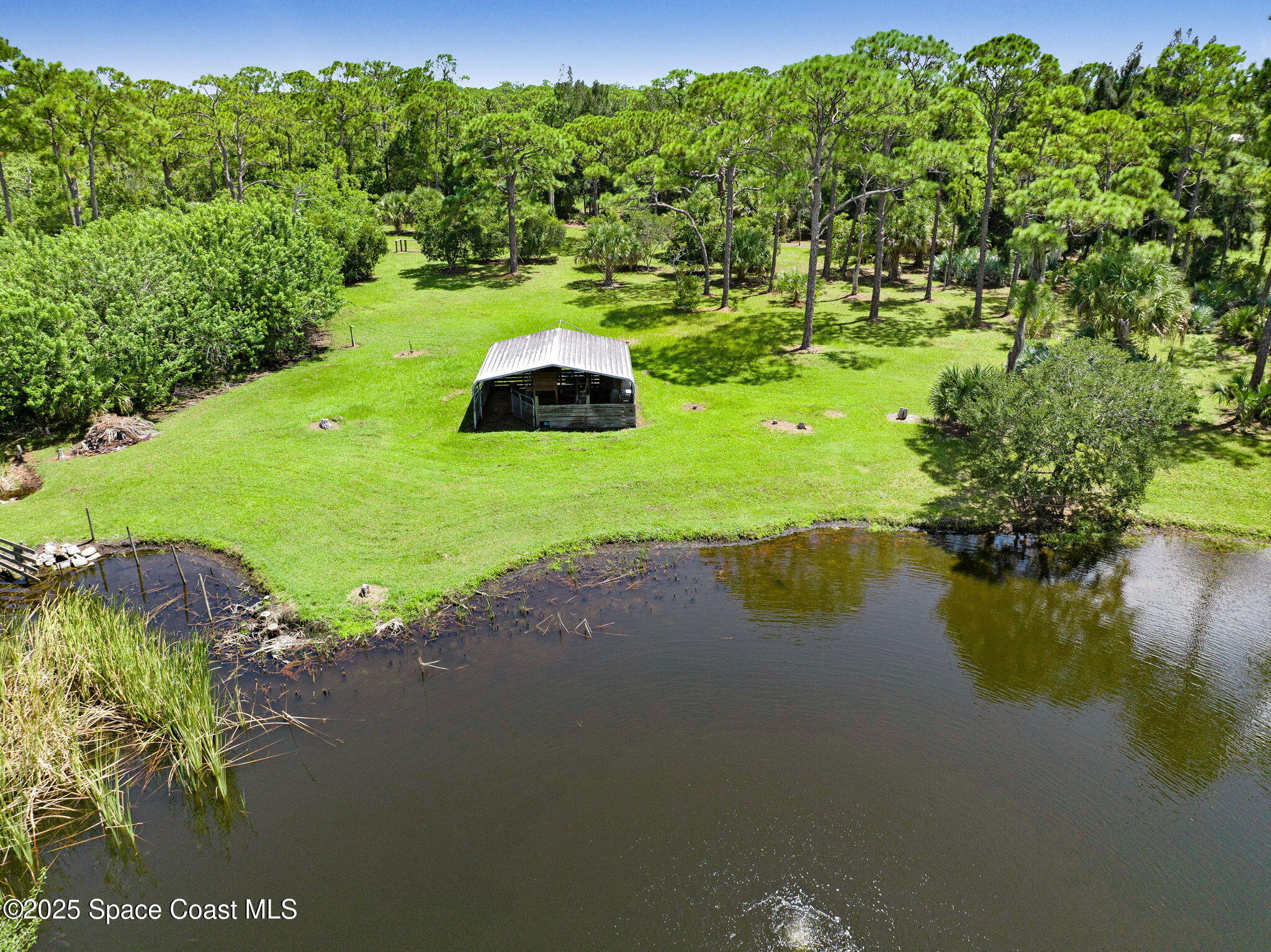 4495 Sand Point Road Grant, FL 32949 - Photo 17 of 87 a view of a lake with a yard