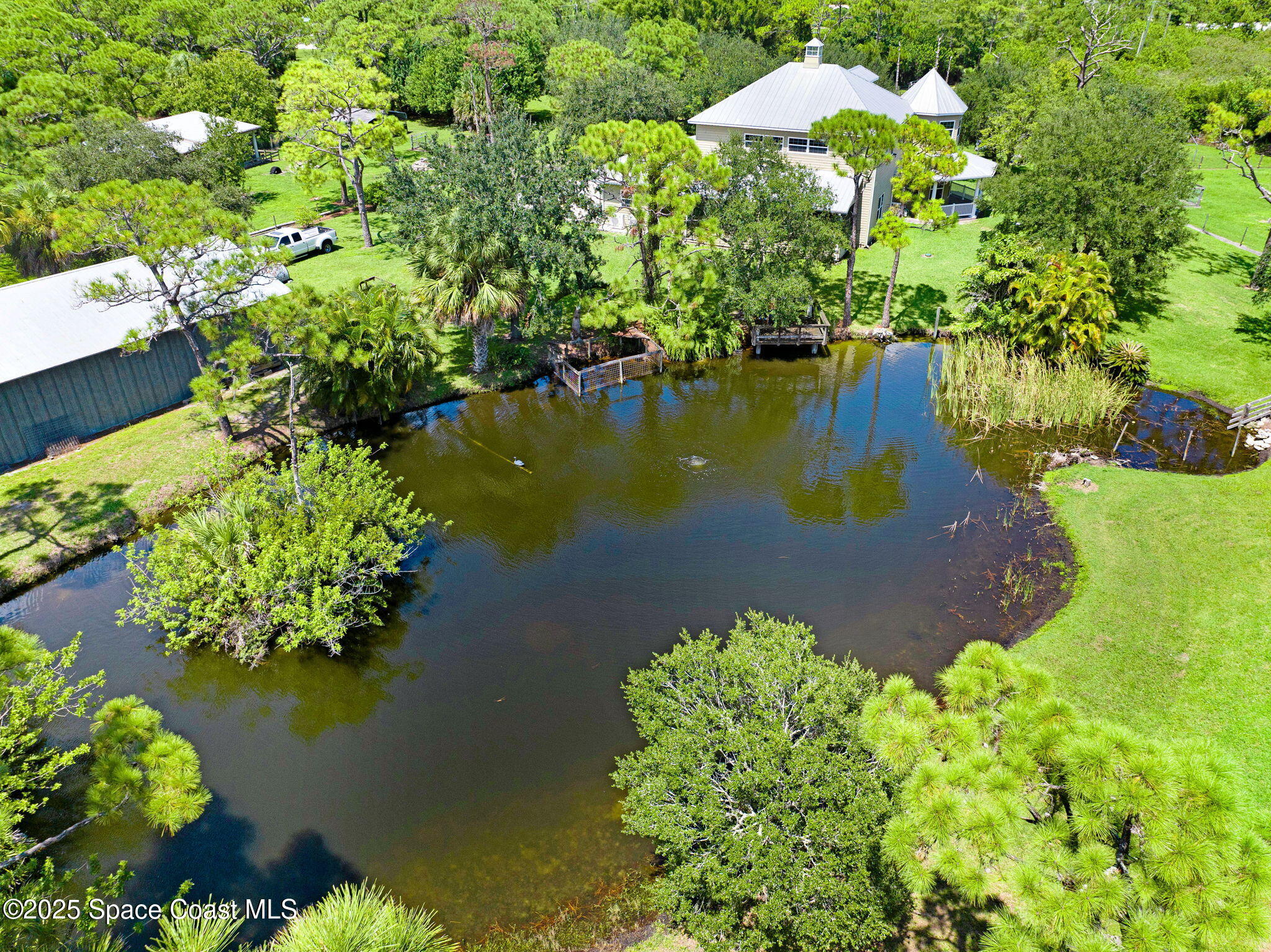 4495 Sand Point Road Grant, FL 32949 - Photo 18 of 87 a view of a lake with a yard