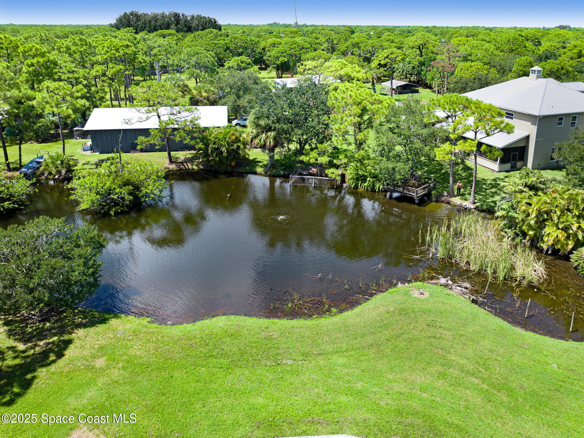 4495 Sand Point Road Grant, FL 32949 - Photo 19 of 87 a view of a lake with a house in the background