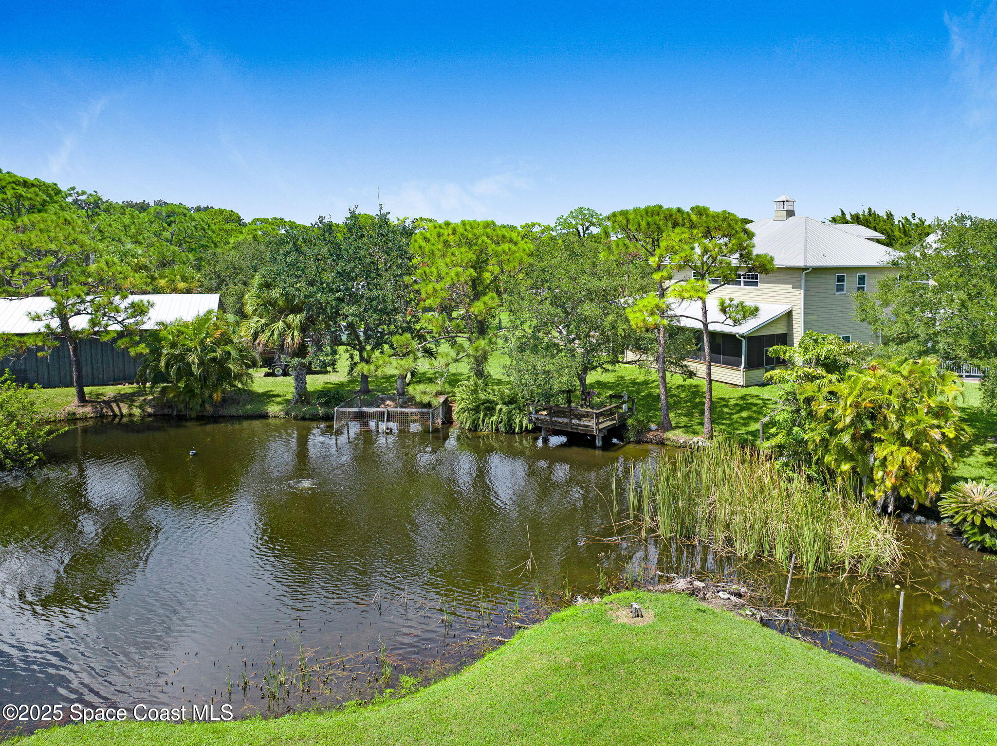 4495 Sand Point Road Grant, FL 32949 - Photo 20 of 87 a view of a lake with a yard