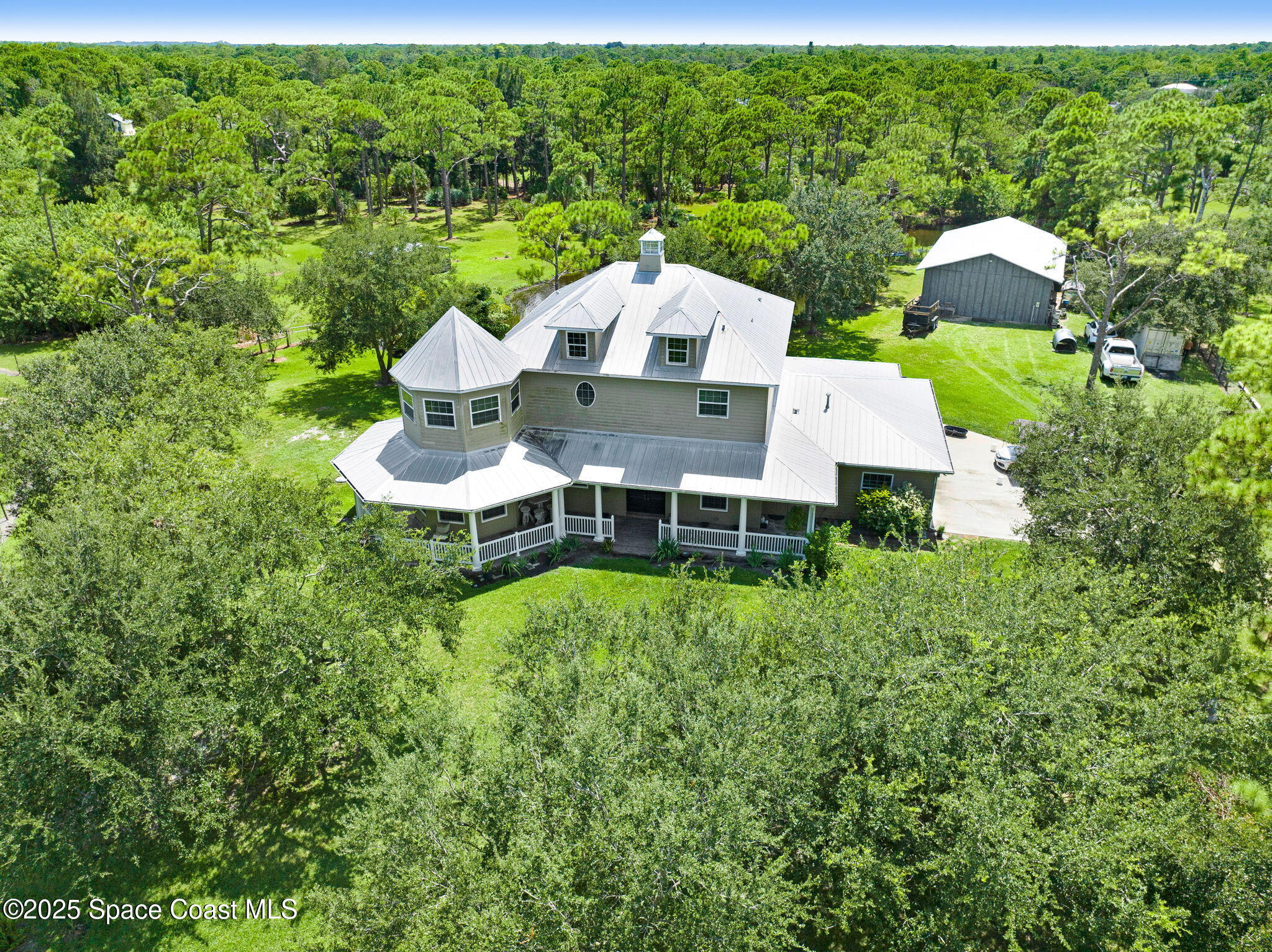 4495 Sand Point Road Grant, FL 32949 - Photo 2 of 87 an aerial view of a house with a yard garden and outdoor seating
