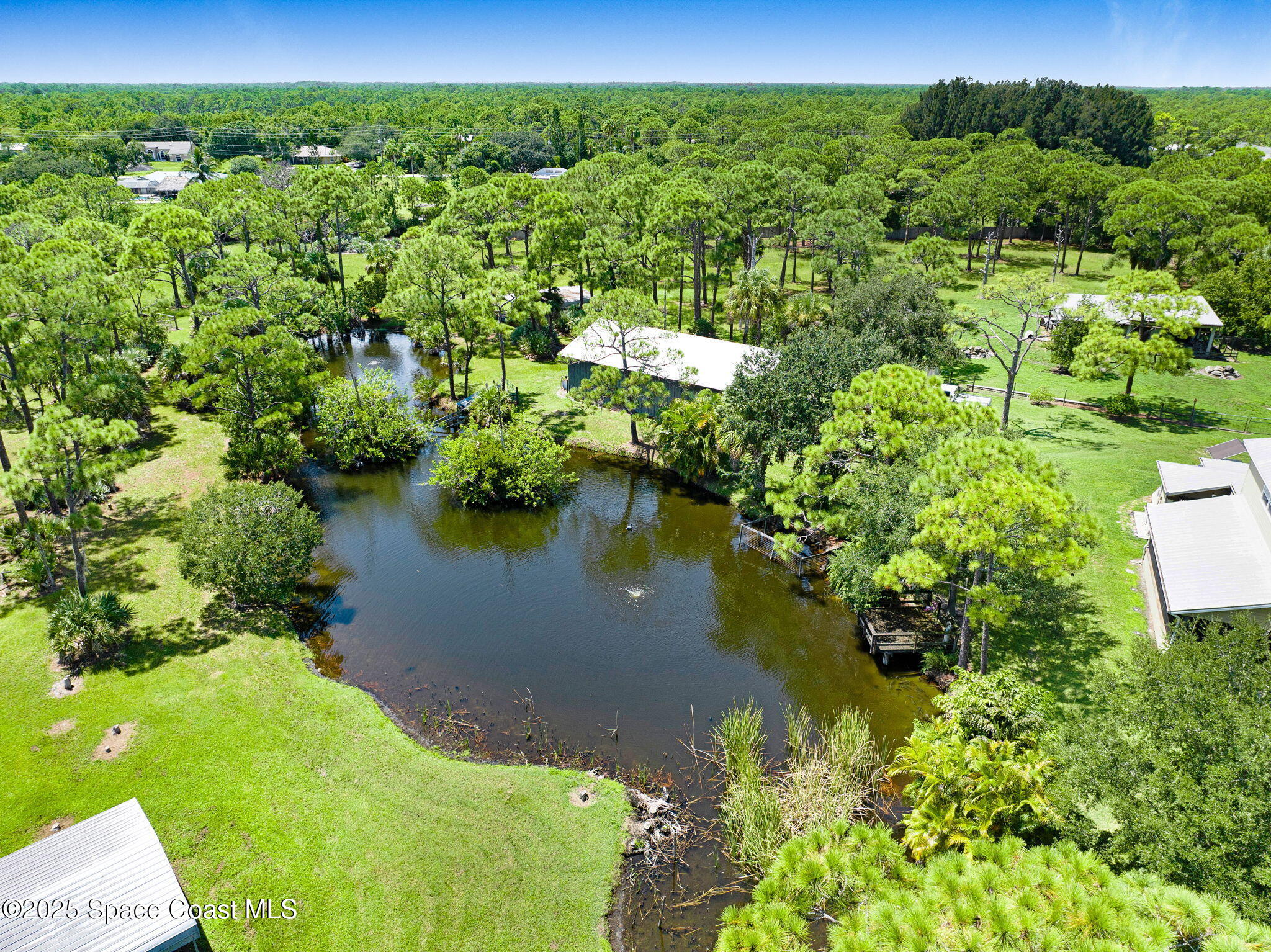 4495 Sand Point Road Grant, FL 32949 - Photo 21 of 87 a view of a lake with a house