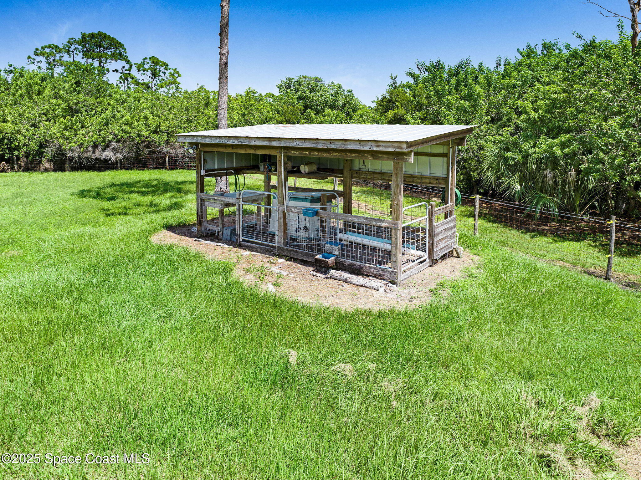 4495 Sand Point Road Grant, FL 32949 - Photo 23 of 87 a view of a deck with a big yard potted plants and large tree