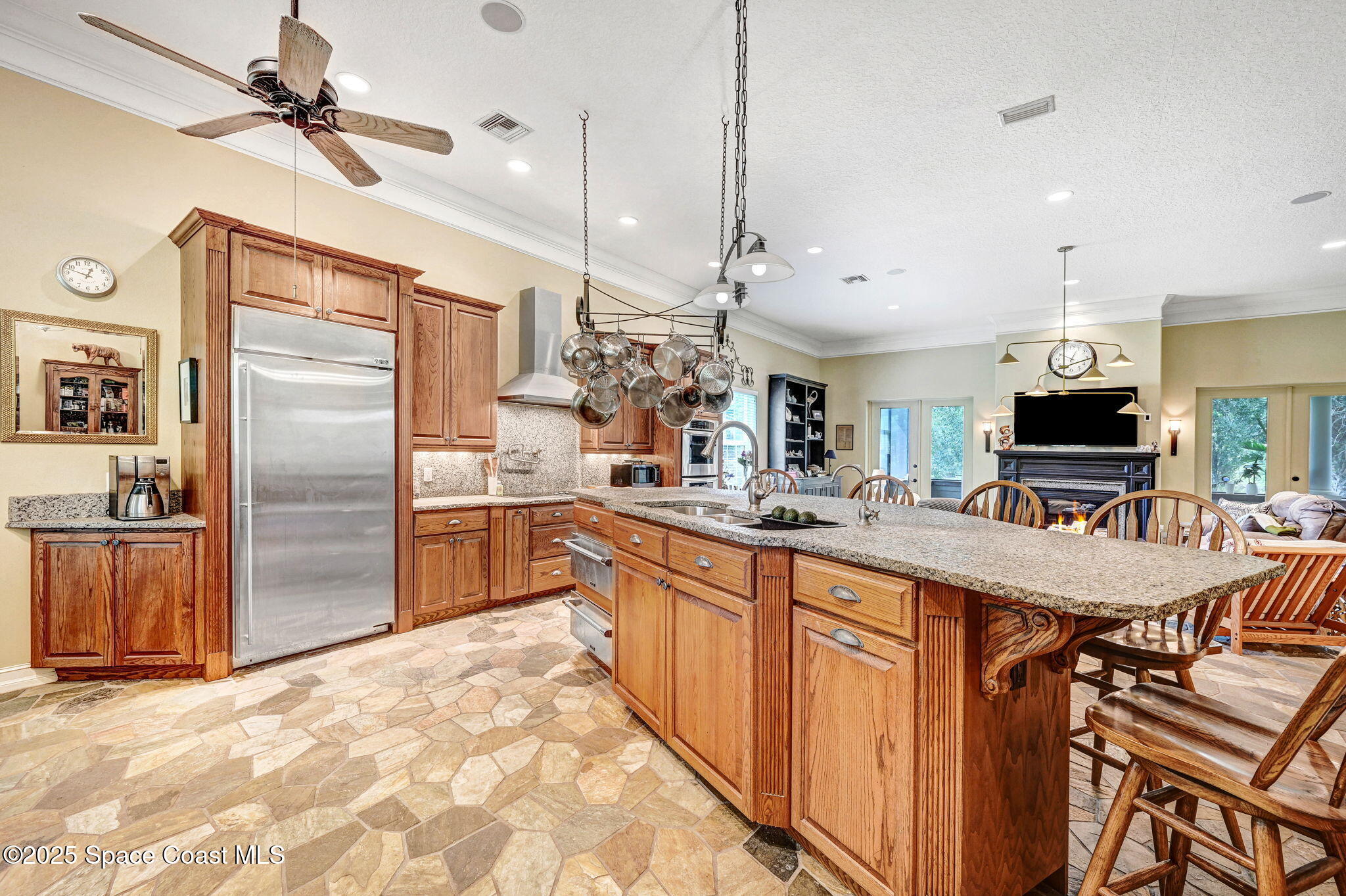 4495 Sand Point Road Grant, FL 32949 - Photo 37 of 87 a kitchen with stainless steel appliances kitchen island granite countertop a refrigerator a oven a sink with a countertop and chairs