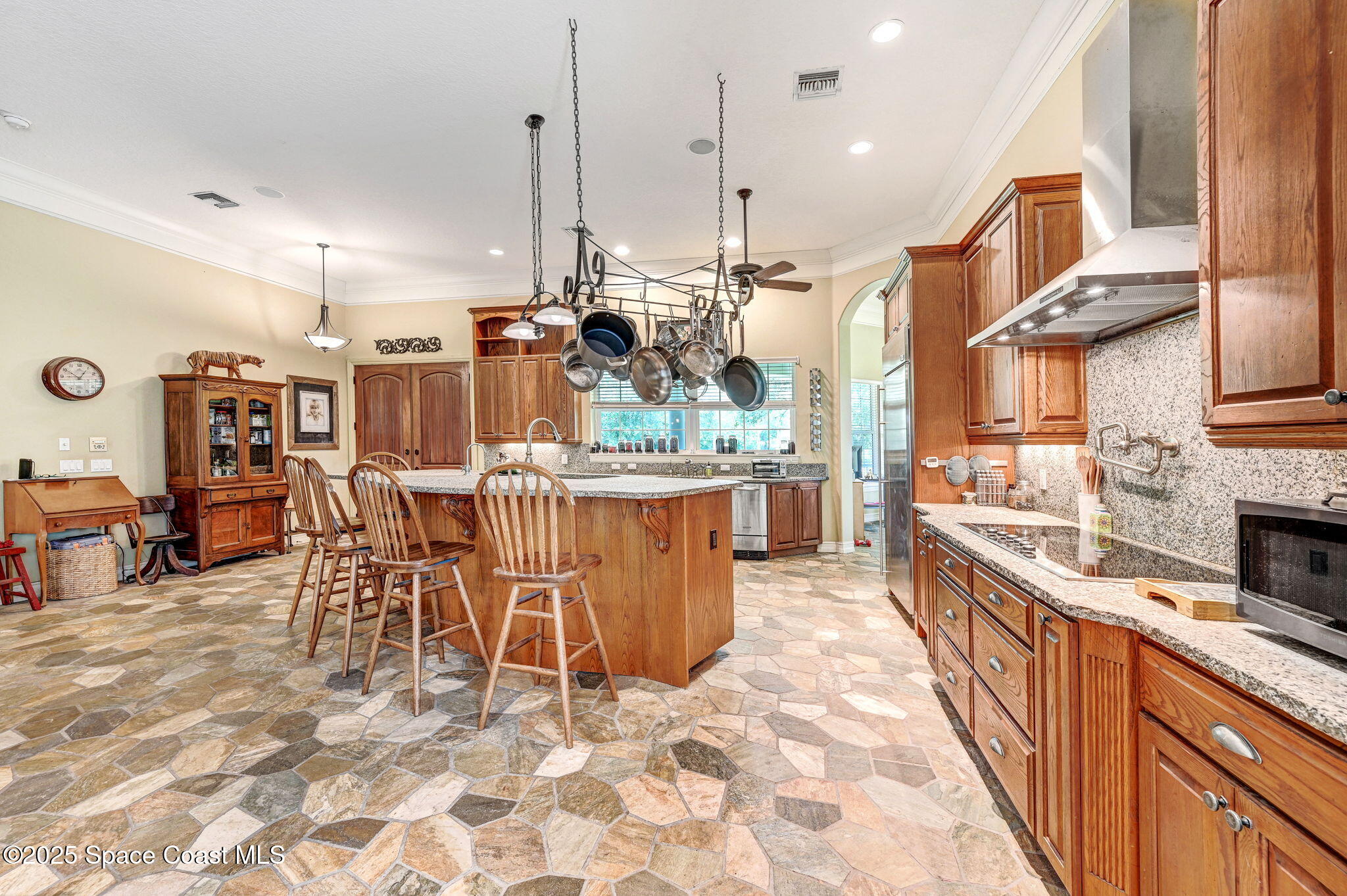 4495 Sand Point Road Grant, FL 32949 - Photo 41 of 87 a kitchen with stainless steel appliances kitchen island granite countertop a table chairs sink and cabinets
