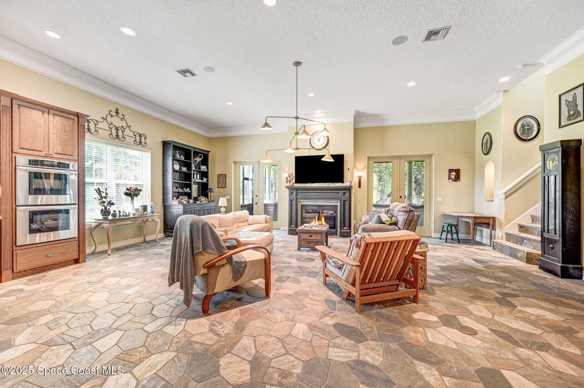 4495 Sand Point Road Grant, FL 32949 - Photo 44 of 87 a living room with furniture a fireplace and a flat screen tv