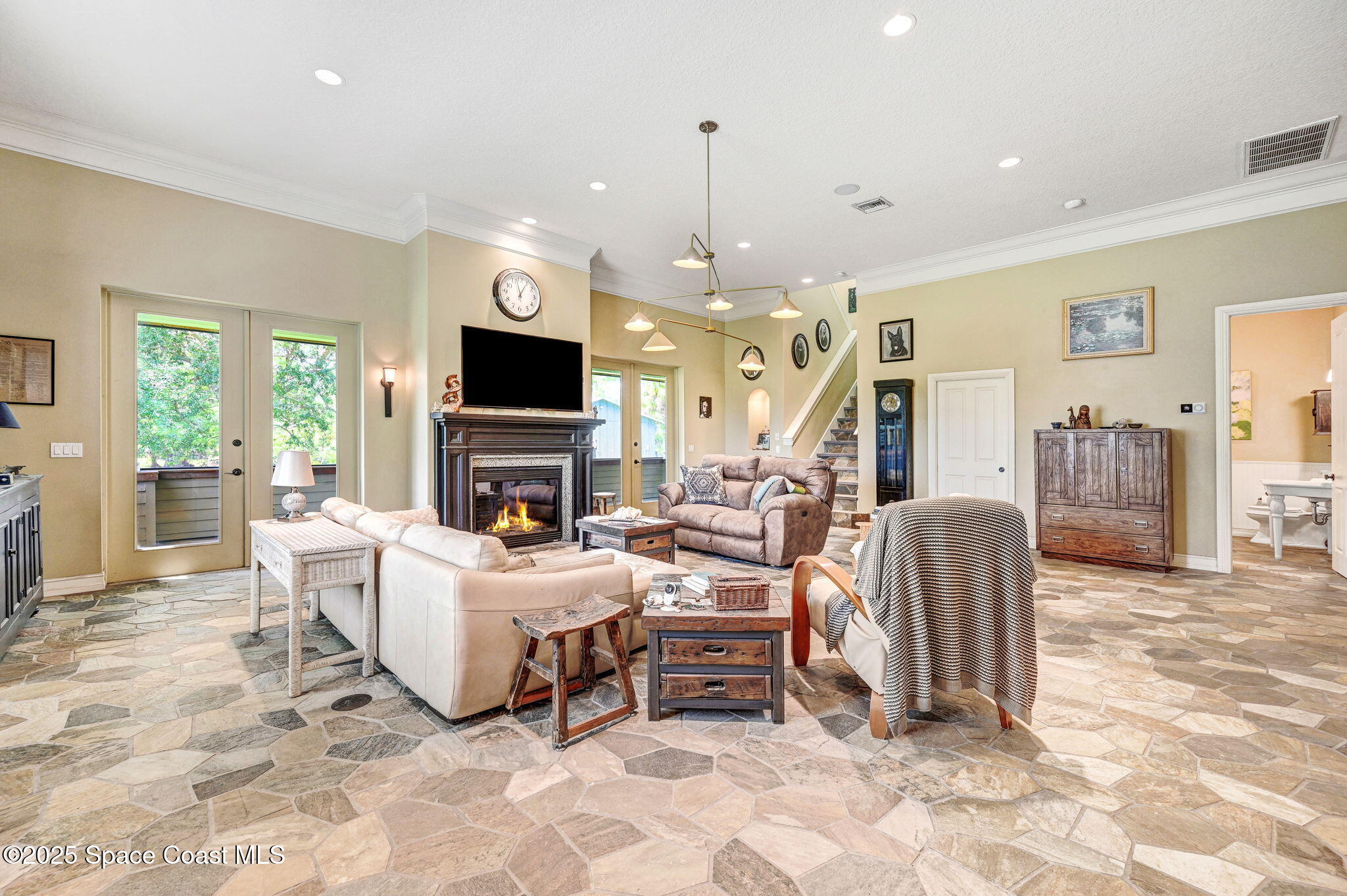 4495 Sand Point Road Grant, FL 32949 - Photo 45 of 87 a living room with furniture a fireplace and a flat screen tv