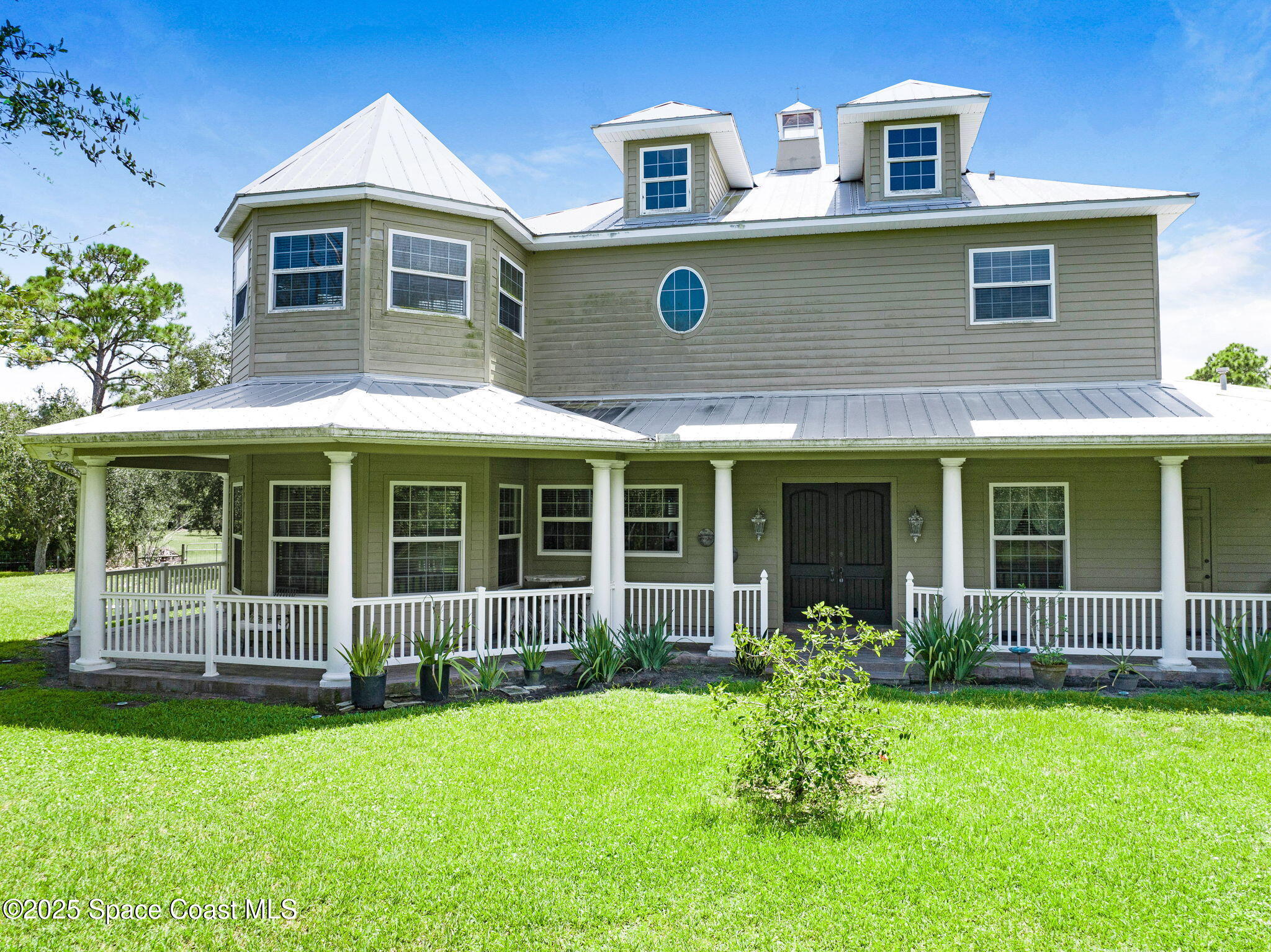 4495 Sand Point Road Grant, FL 32949 - Photo 5 of 87 a front view of a house with garden