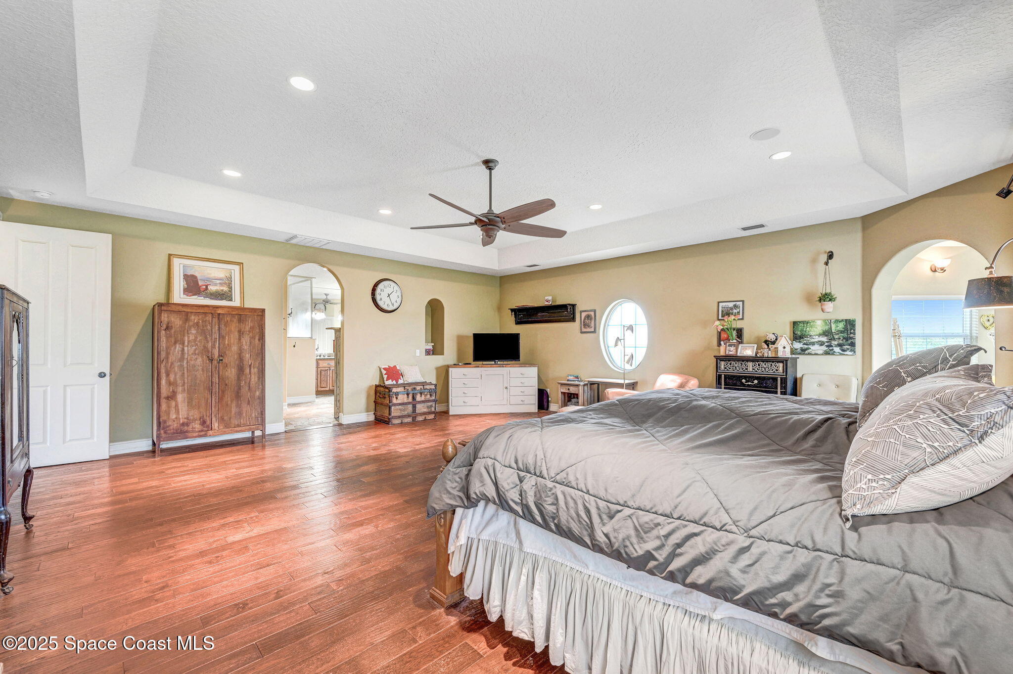 4495 Sand Point Road Grant, FL 32949 - Photo 63 of 87 a bedroom with a large bed and wooden floor