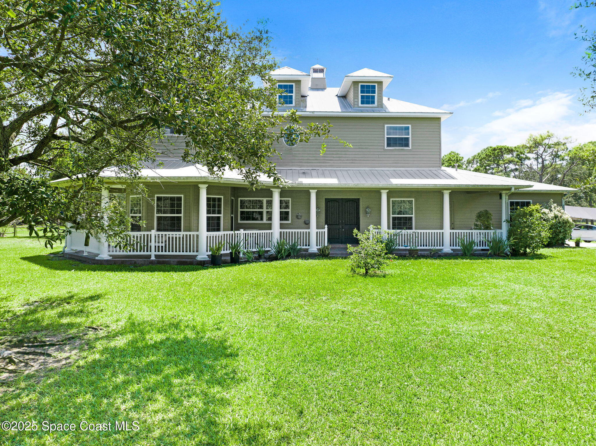 4495 Sand Point Road Grant, FL 32949 - Photo 83 of 87 a front view of a house with a garden