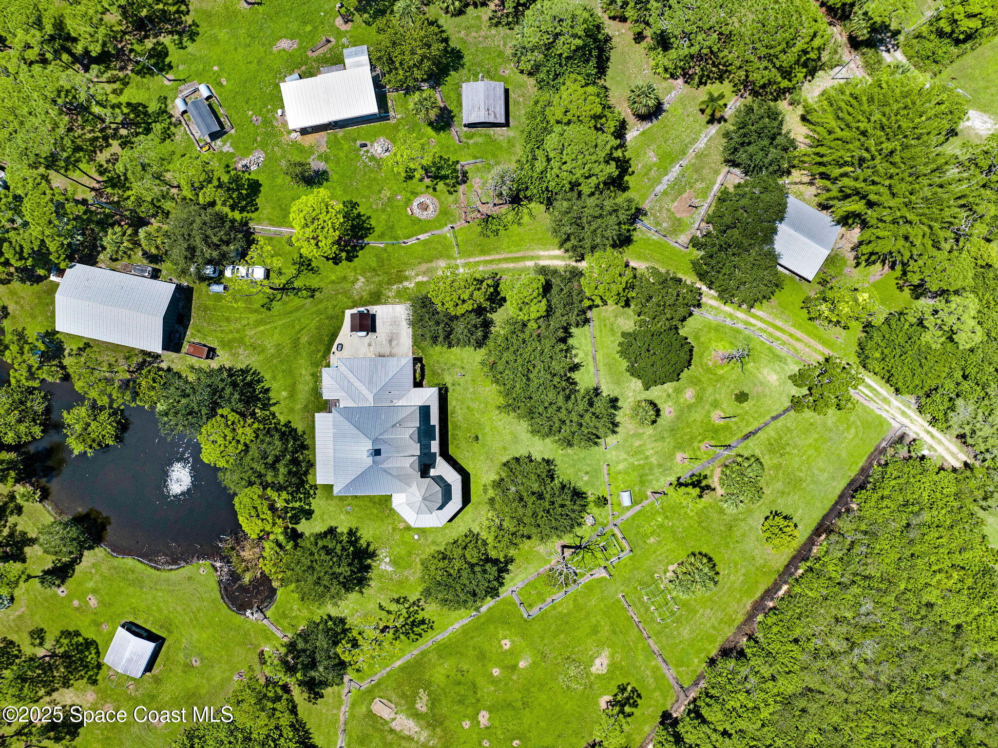 4495 Sand Point Road Grant, FL 32949 - Photo 9 of 87 an aerial view of a house with a yard and garden