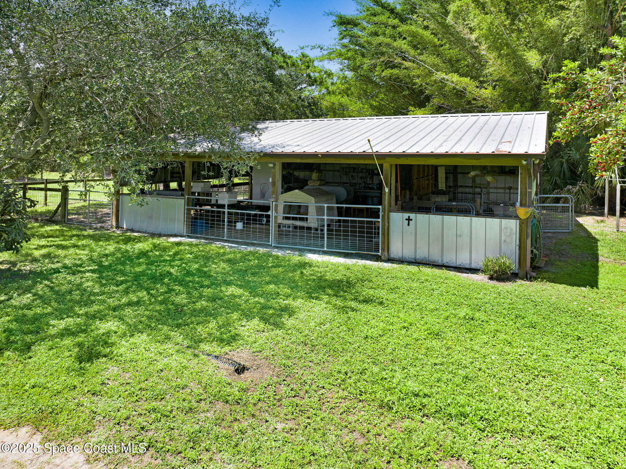 4495 Sand Point Road Grant, FL 32949 - Photo 10 of 87 a view of a house with a small yard and wooden fence