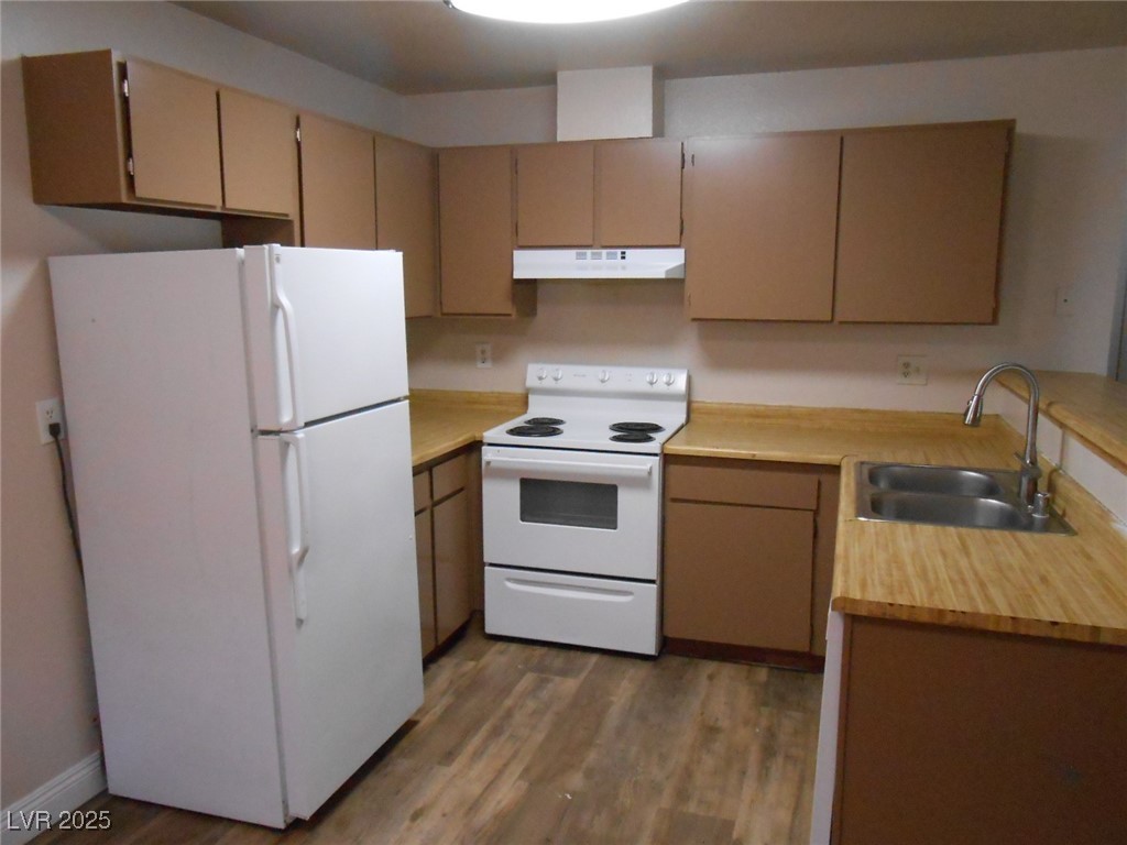 4720 Krissylouise Way, Unit B Las Vegas, NV 89121 - Photo 3 of 14 Kitchen with white appliances, light countertops, light wood-style flooring, and under cabinet range hood