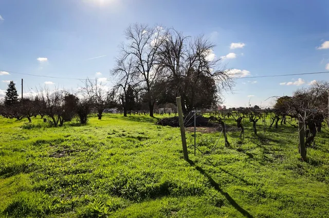 an aerial view of residential houses with outdoor space and street view