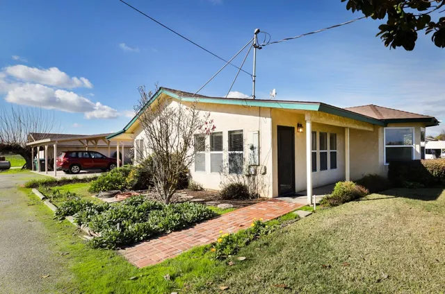 a front view of a house with garden