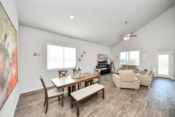 a large kitchen with a table and chairs in it