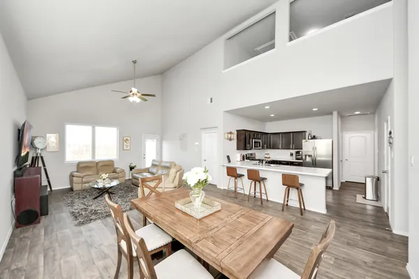 a large kitchen with a table and chairs