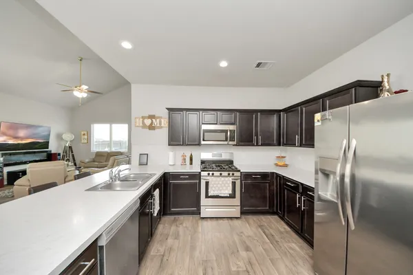 a kitchen with a sink stove and microwave