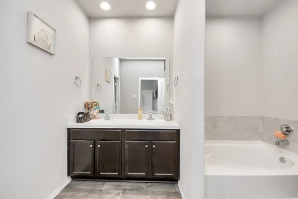 a bathroom with a bathtub and a sink