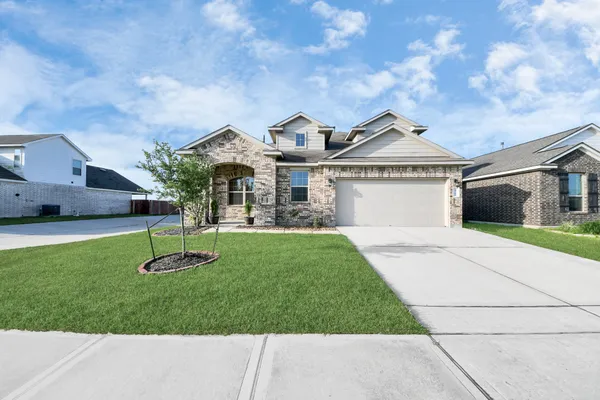 a front view of a house with a yard and a garage