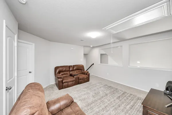 a living room with furniture and a piano