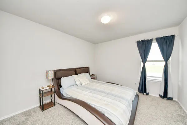 a bedroom with bed and a window